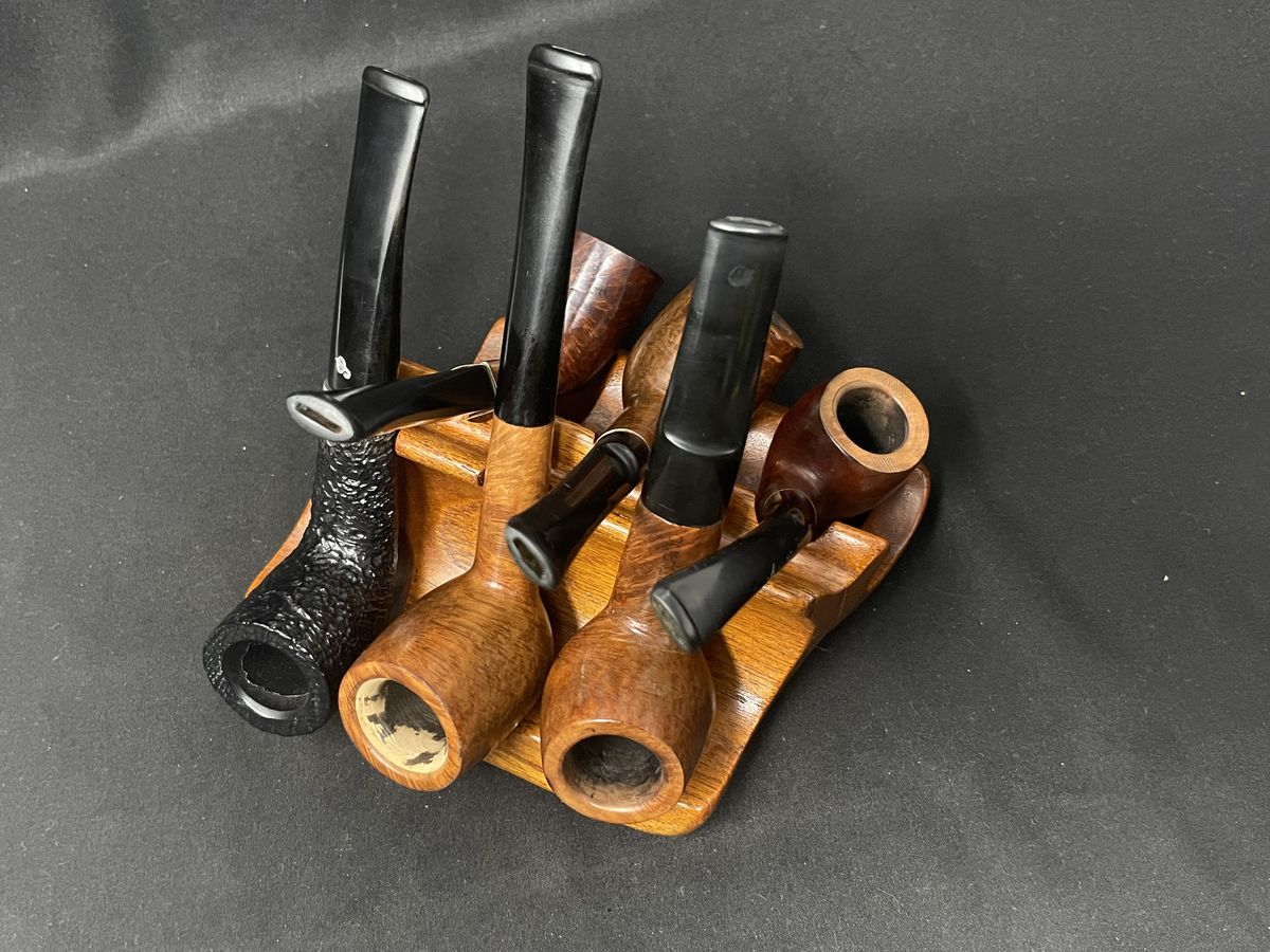 Estate pipes resting on a carved wooden rack